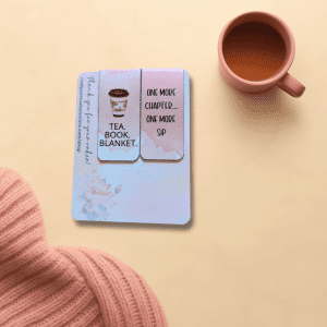 Tea • Book • Blanket Bookmark Duo featuring cozy magnetic bookmarks for readers, displaying a coffee cup design alongside the text "ONE MORE CHAPTER... ONE MORE SIP" on a soft gradient background. A pink mug and knitted blanket are also shown.