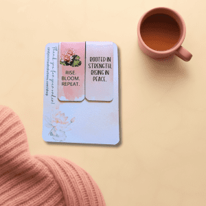 Rise & Bloom Bookmark Duo featuring two magnetic bookmarks with floral designs in pastel colors. One bookmark reads 'RISE. BLOOM. REPEAT.' while the other states 'ROOTED IN STRENGTH. RISING IN PEACE.' Encouraging magnetic bookmarks gift for readers.